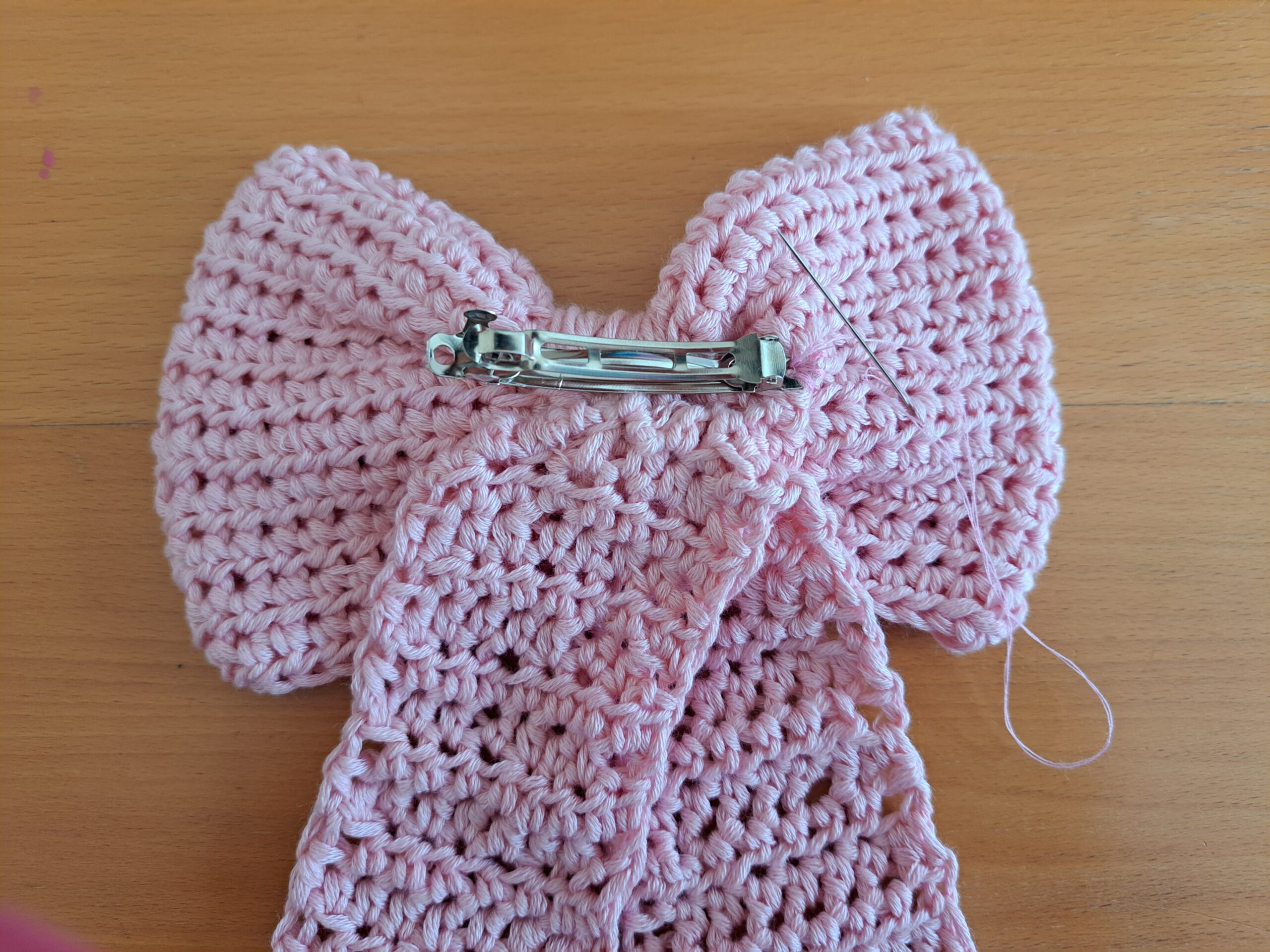 Sew the hair slide onto the back of the bow